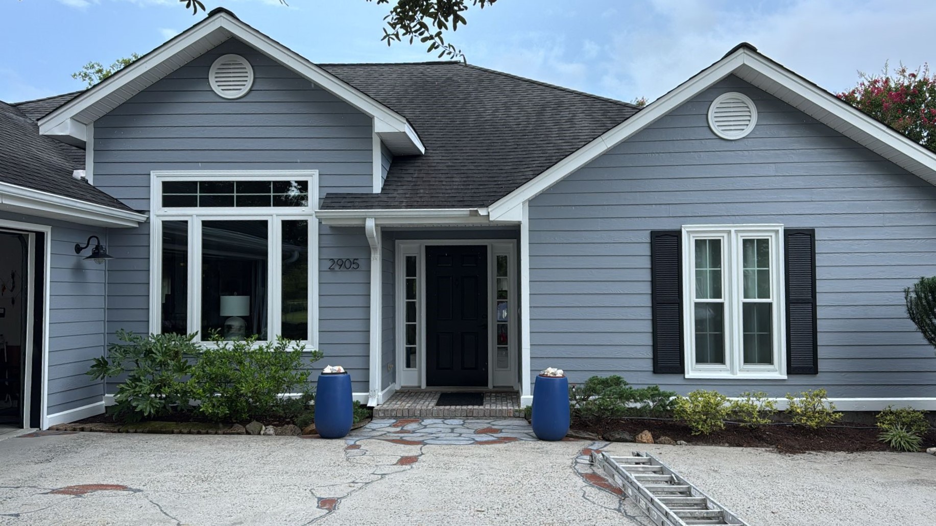 Freshly painted charcoal exterior wall with crisp white trim