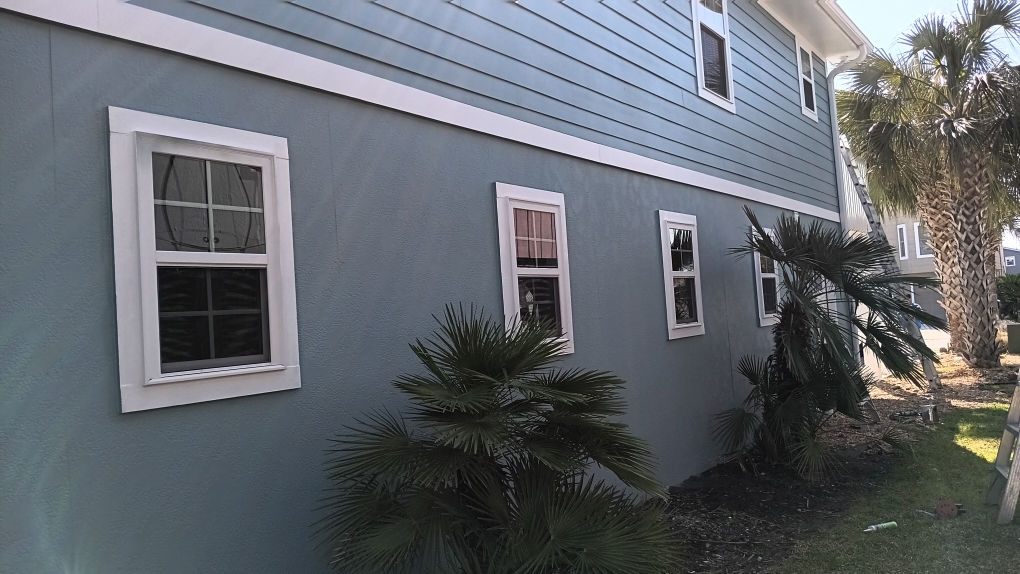 Freshly painted charcoal exterior wall with crisp white trim