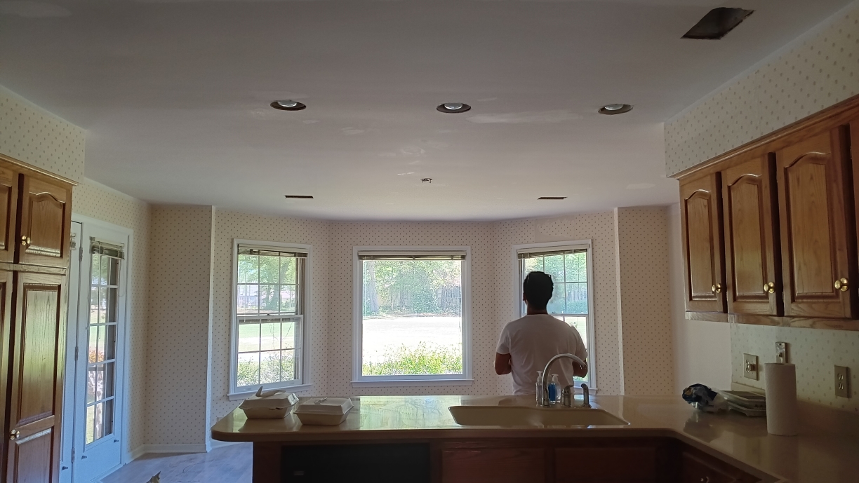 Freshly painted charcoal exterior wall with crisp white trim