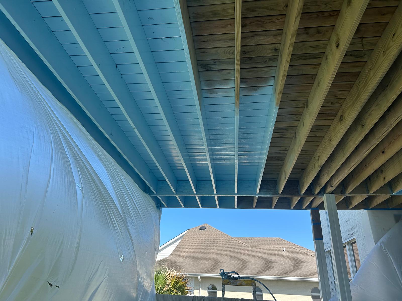 Freshly painted charcoal exterior wall with crisp white trim