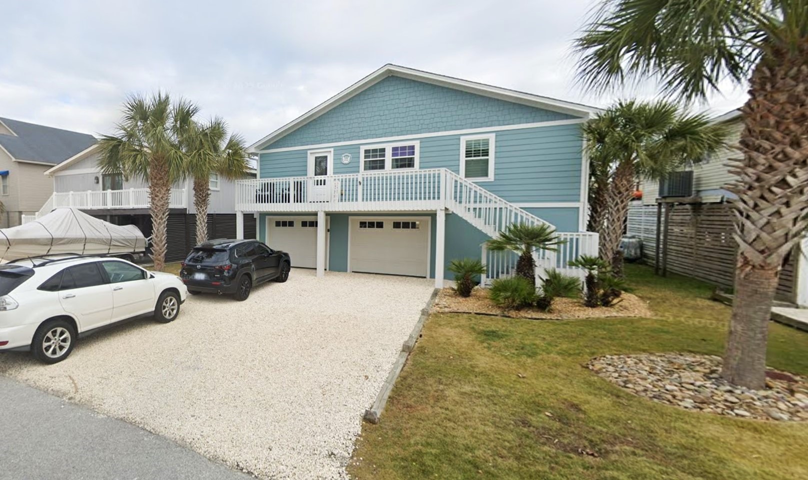 Professional painter from Erazo's Painting LLC doing precision detail work on a residential exterior